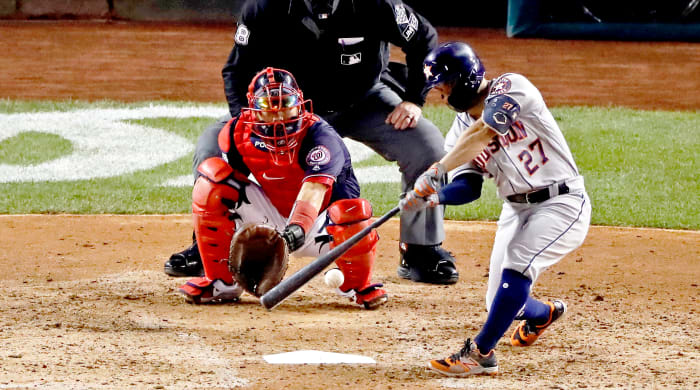 Oct 25, 2019; Washington, DC, USA; Houston Astros second baseman Jose Altuve (27) hits a double during the fifth inning against the Washington Nationals in game three of the 2019 World Series at Nationals Park. Mandatory Credit: Geoff Burke-USA TODAY Sports
